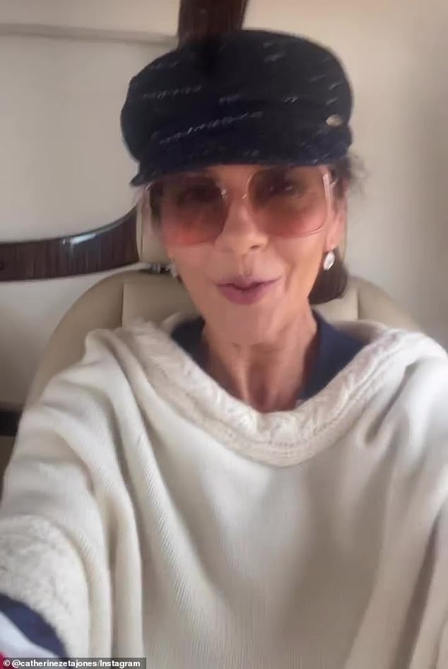 Looking good: The actress then shared a beaming video on camera donning a white sweater, black hat and large sunglasses while in a helicopter