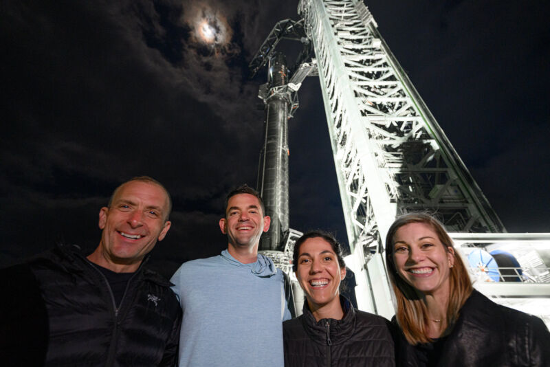 The Polaris Dawn crew, left to right: Scott Poteet, Jared Isaacman, Sarah Gillis and Anna Menon, pose in front of SpaceX's Super Heavy rocket in South Texas.