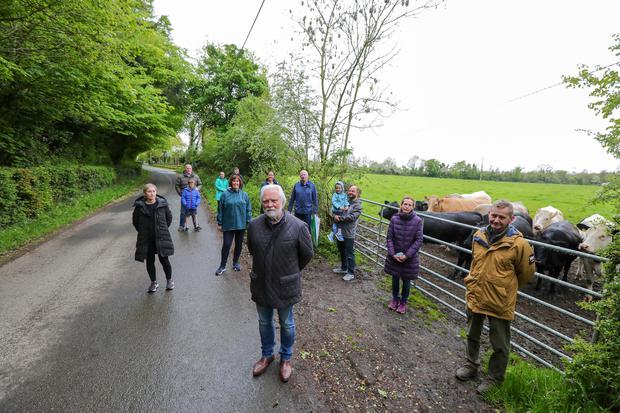 Protest: Conor Maguire (centre) with other local residents at the entrance to a field in Dunnstown, Naas, Co Kildare, where a battery storage facility is proposed.  Photo: Gerry Mooney