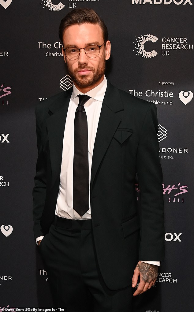Dapper gent: Former One Direction star Liam looked chic in a black suit and matching tie, as he wore a pair of circular-rimmed glasses