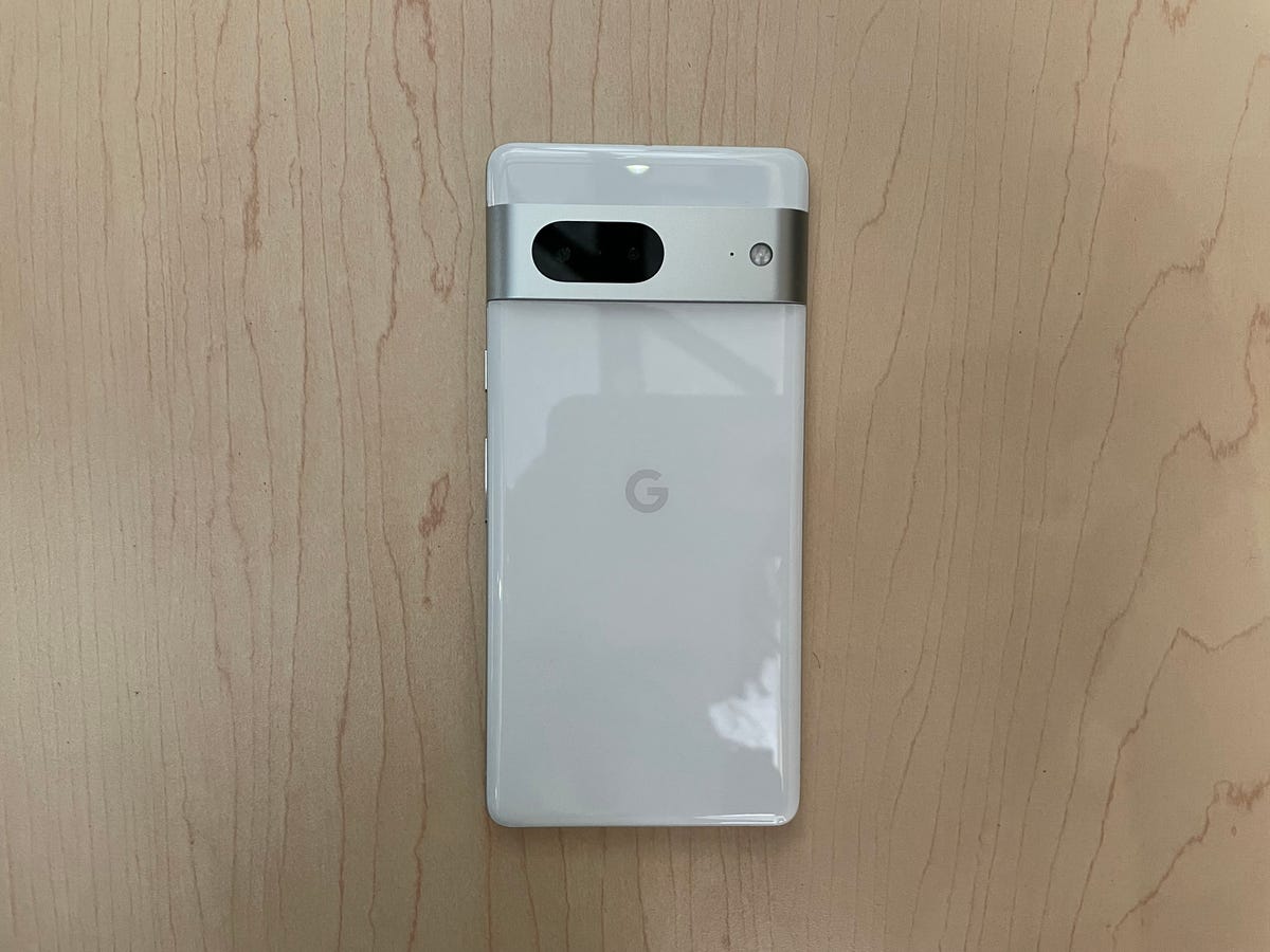 Google Pixel 7 in white on a wooden background